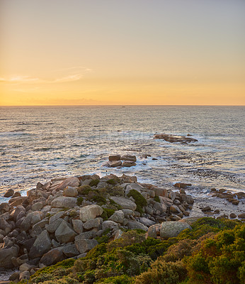 Buy stock photo Copyspace landscape of an ocean view against a sunset sky in summer. Beautiful and calm scenery from the beach seaside while the sun sets in the distance. Natural environment of the sea at dawn