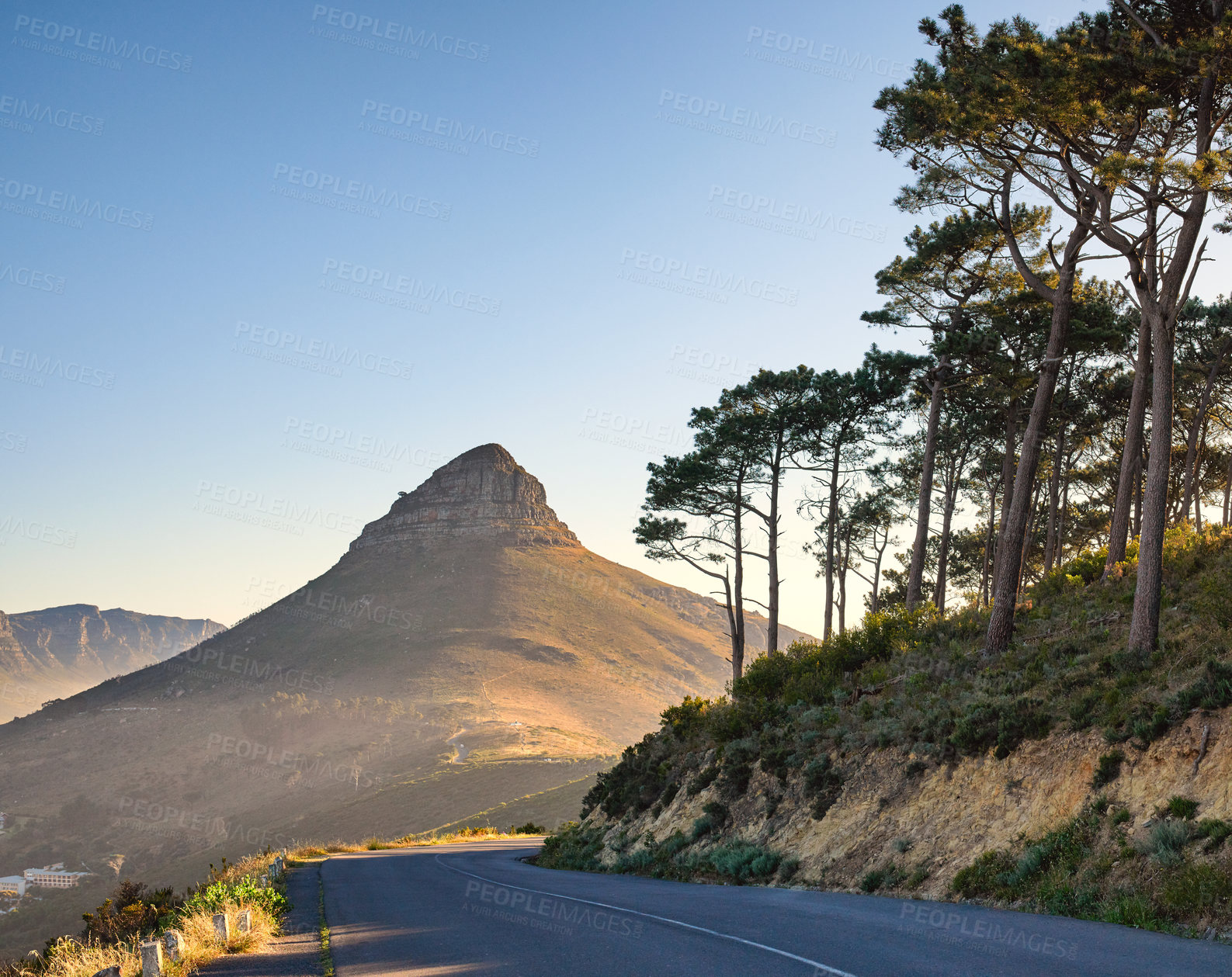 Buy stock photo Beautiful view of mountain named Lion's Head on sunny Summer day. Nature around includes green trees ahead with road beside to enjoy drives. Area is in Cape Town in the Western Cape of South Africa.
