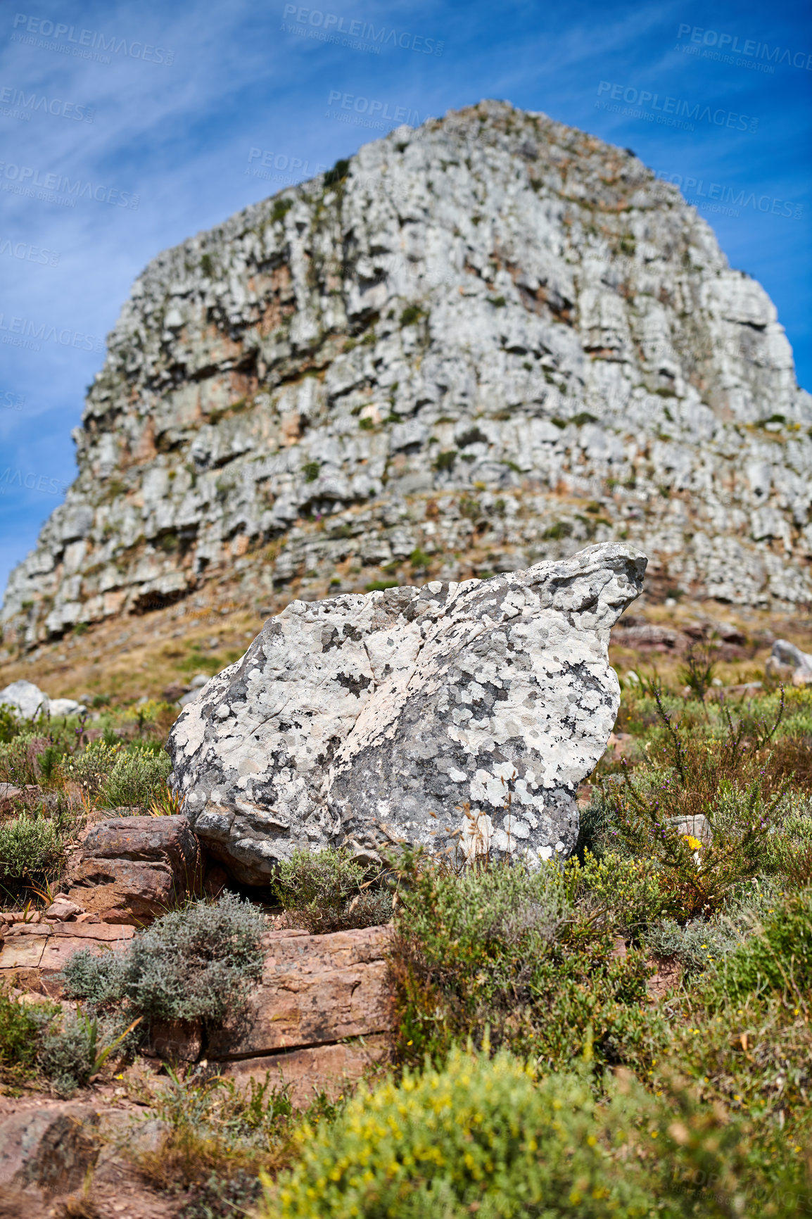 Buy stock photo Mountain view, rocks and boulders in uncultivated, rough and dangerous hiking terrain in secluded overseas nature reserve. Lush green bushes or shrubs growing among flora and plants in quiet location