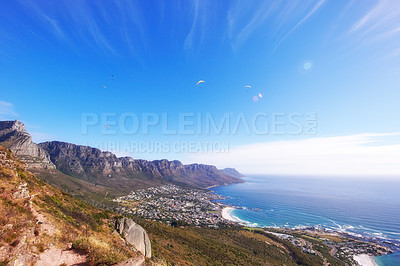 Buy stock photo Beautiful panoramic view of Table mountain in Cape Town, South Africa, with a view of the ocean and copy space. Lush green bushes and trees growing on rocky peaks in serene, peaceful nature 