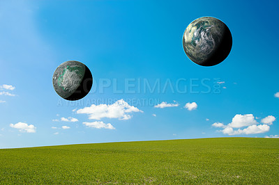 Buy stock photo Two 3D solar planets symbolising world or earth day, universal ecosystem in remote landscape, field or meadow. Astrophysics or celestial study of flat earth theory, planetary or astrology observation