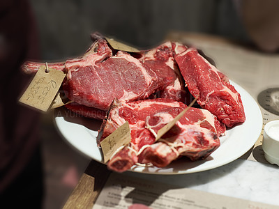 Buy stock photo Top view of meat being prepared to be sold at a butcher. Delicious beef steak being processed and sorted to make lunch or dinner in a kitchen at home. Food high in protein coming fresh from a farm