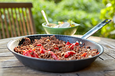 Buy stock photo A delicious meal with cooked beef meat and pepper vegetables. Chili con carne stew dish served for dinner at an outdoors restaurant. Texture detail of spicy homemade food in a pan on a table