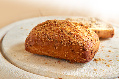 Buy stock photo Closeup of freshly baked bread at a bakery with copy space. Zoom in on homemade rye loaves ready to be eaten and enjoyed as a delicious meal. Macro details of a fresh seed bun on display on a counter