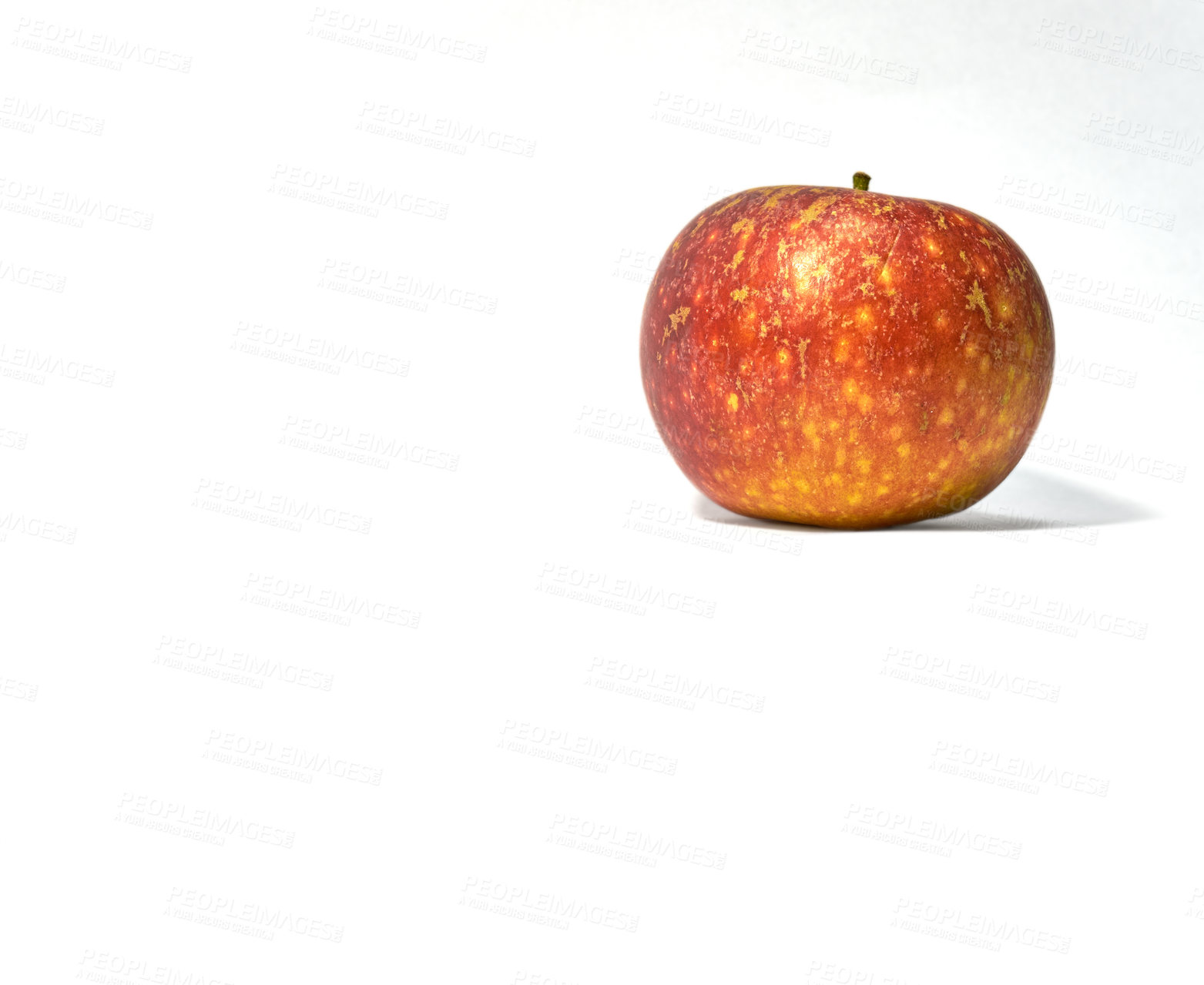 Buy stock photo Closeup of a red apple in studio isolated on a white background. Eat healthy and watch your diet. Fruit contains essential vitamins to boost your immunity. A snack vegans and vegetarians can enjoy