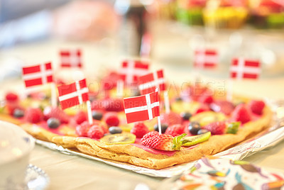 Buy stock photo Danish fruit pastry for dessert to celebrate patriotism on Constitution Day in June. Annual holiday feast in Denmark with national flags in food. Fresh summer produce on a baked puff pastry