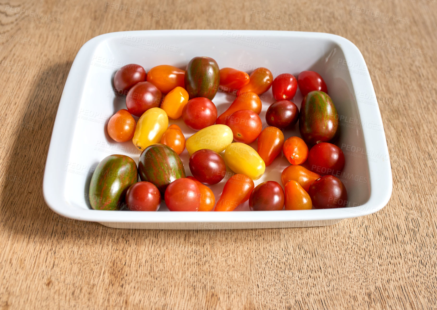 Buy stock photo Many cherry tomatoes in a bowl. Lots of colorful organic tomato vegetables for a healthy veggie platter. Multicolored small delicious fruit, perfect for vegan vegetarian food, appetizers or snack