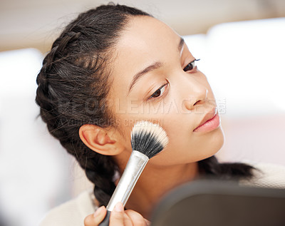 Buy stock photo Shot of a young woman applying makeup during her beauty routine at home