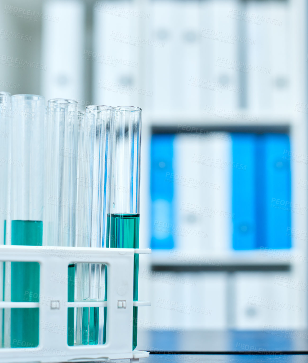 Buy stock photo Closeup shot of test tubes in a tray on a table in a lab