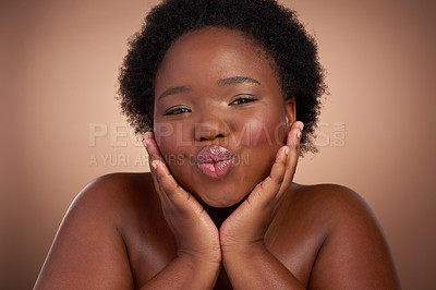 Buy stock photo Kiss, portrait and black woman in studio for beauty or skincare with make up, cosmetics and wellness. Person, isolated and beige background with lip balm for glow or self care, aesthetic and pout.