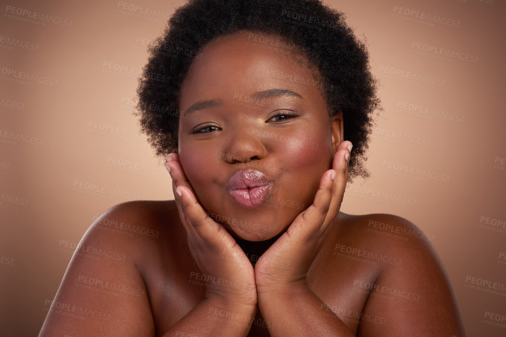 Buy stock photo Kiss, portrait and black woman in studio for beauty or skincare with make up, cosmetics and wellness. Person, isolated and beige background with lip balm for glow or self care, aesthetic and pout.