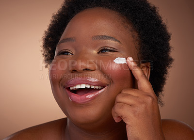 Buy stock photo Studio shot of a beautiful young woman looking happy against a brown background