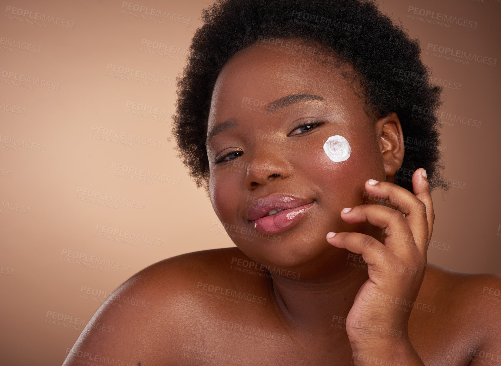 Buy stock photo Studio portrait of a beautiful young woman posing against a brown background