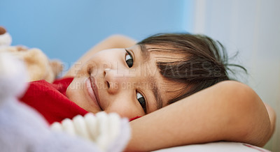 Buy stock photo Portrait of an adorable little boy lying on a bed with his stuffed toys at home