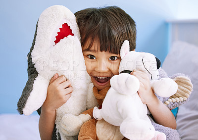 Buy stock photo Portrait of an adorable little boy playing with his stuffed toys at home