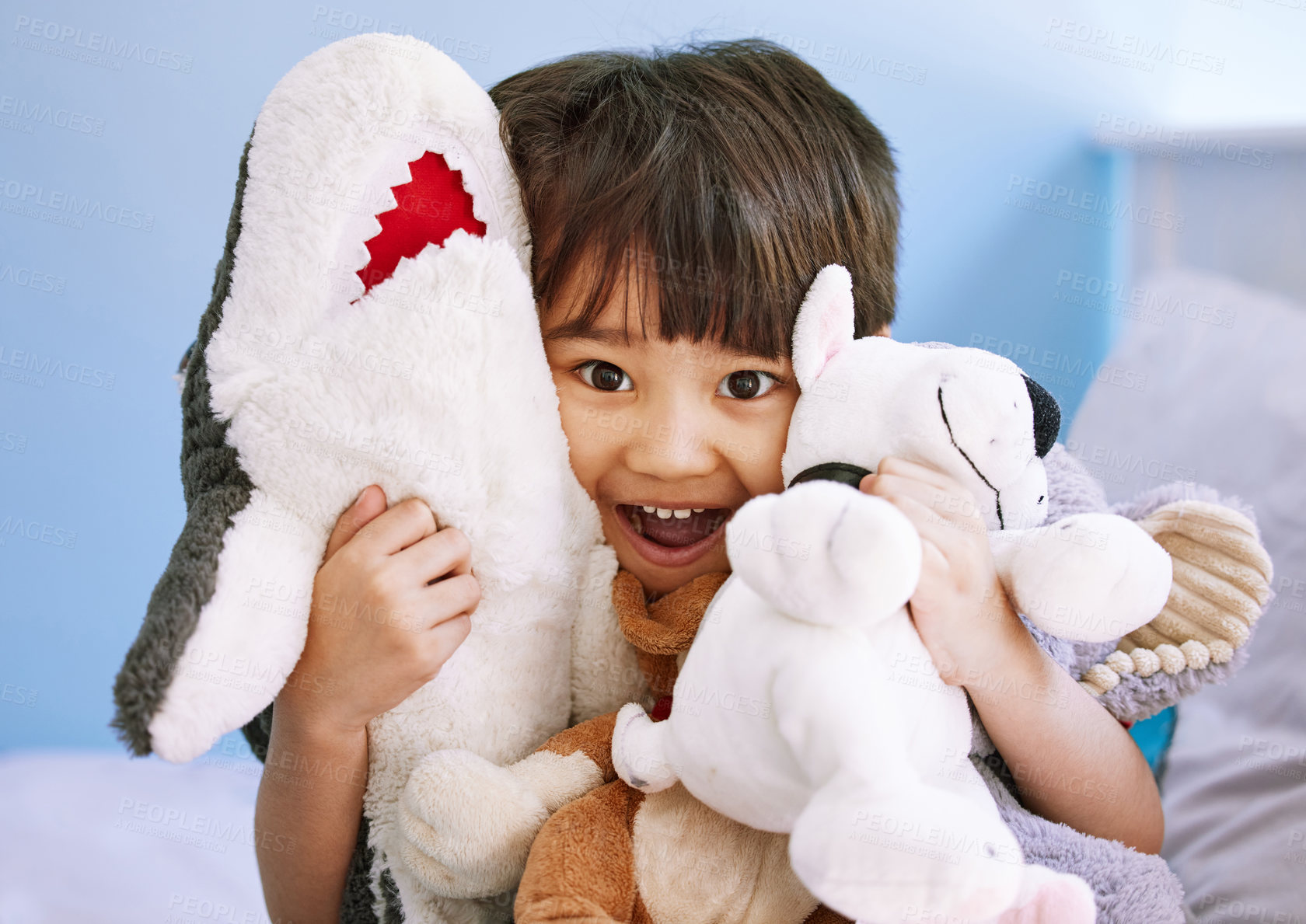 Buy stock photo Portrait of an adorable little boy playing with his stuffed toys at home