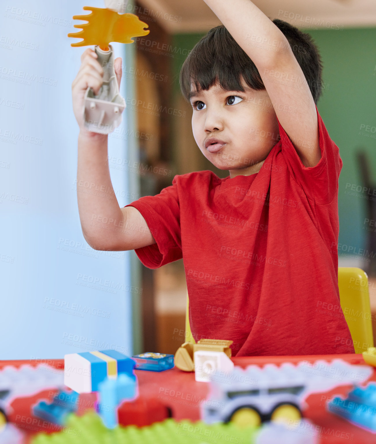 Buy stock photo Shot of an adorable little boy playing with toys at home