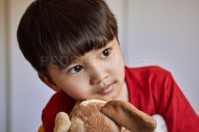 Buy stock photo Shot of an adorable little boy playing with his stuffed toys at home