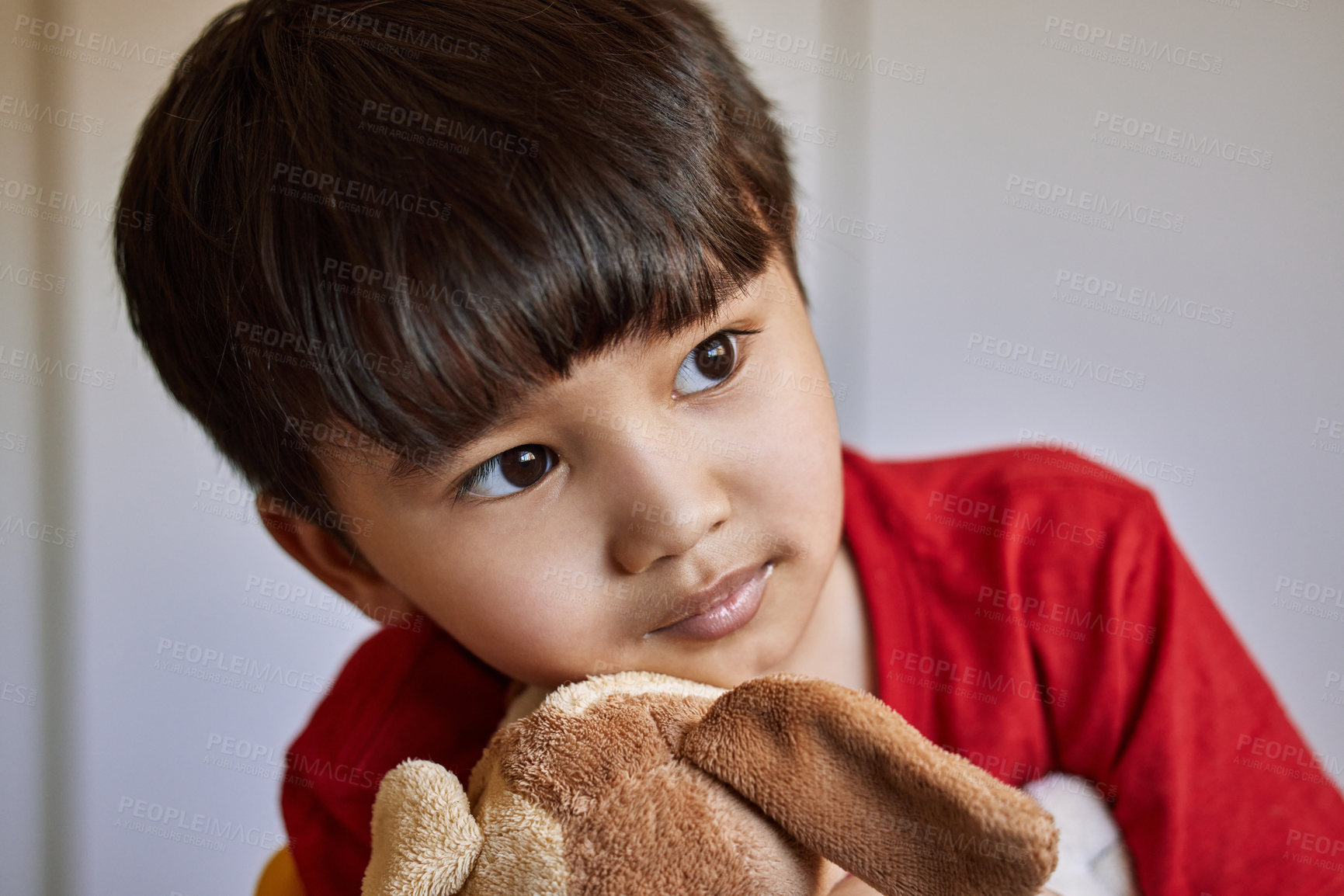 Buy stock photo Shot of an adorable little boy playing with his stuffed toys at home