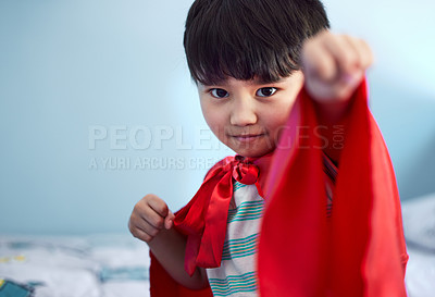 Buy stock photo Portrait of an adorable little boy pretending to be a superhero while playing at home