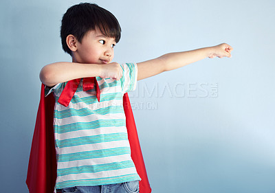 Buy stock photo Boy, studio and superhero cape with happy for child development with playing, confidence and youth for fantasy. Blue background, cosplay and costume with brave or strong with ready to protect freedom