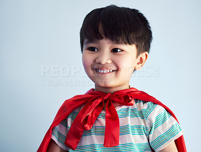 Buy stock photo Studio, boy and superhero cape with smile for child development with playing, confidence and youth for fantasy. Blue background, cosplay and costume with strong or brave with ready to protect freedom