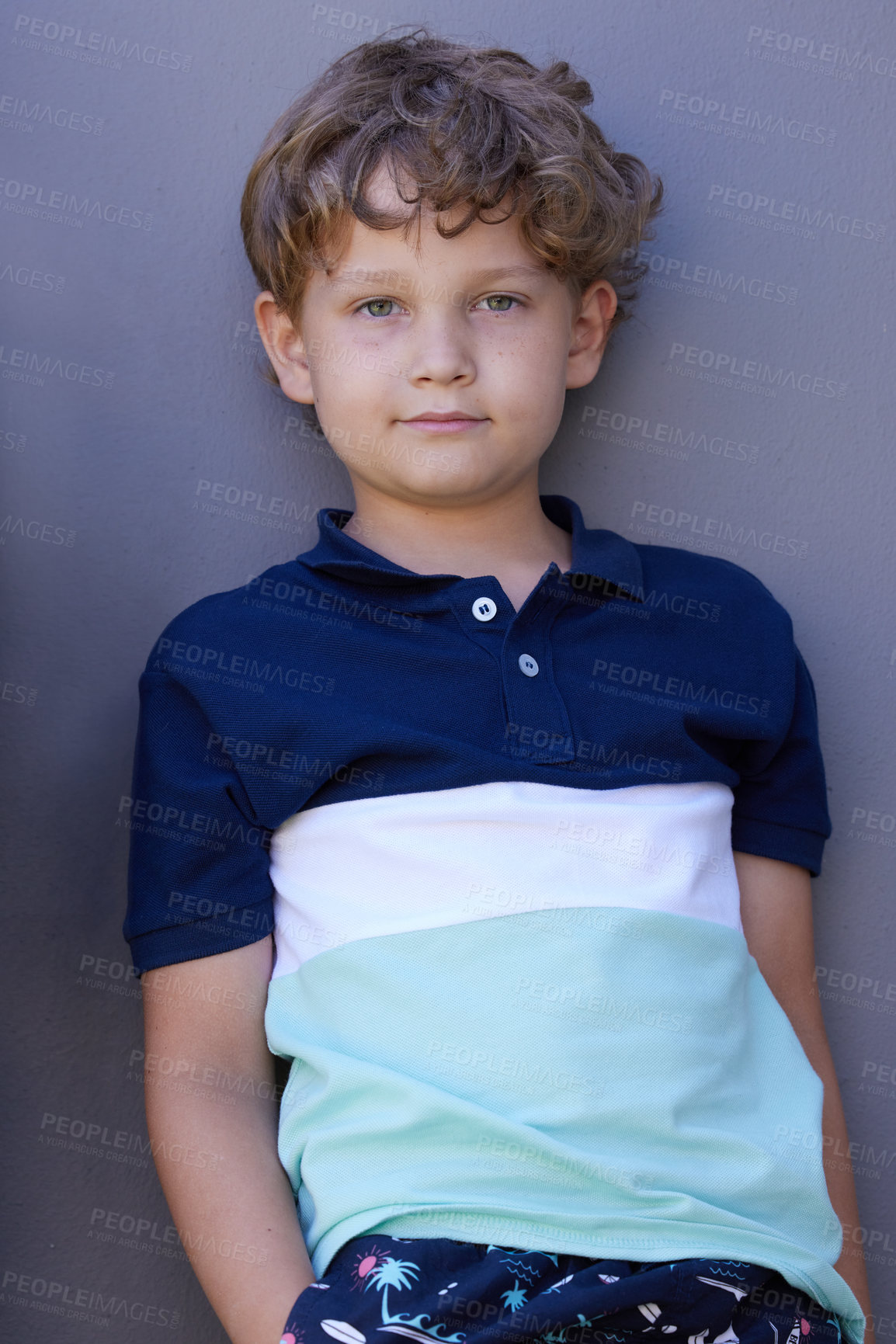 Buy stock photo Portrait of an adorable little boy leaning against a grey background