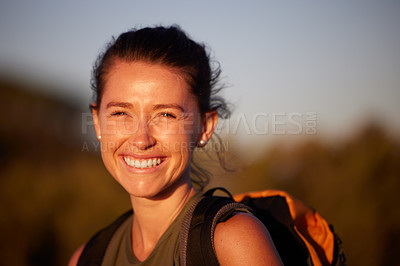 Buy stock photo Cropped shot of a young woman smiling while out hiking