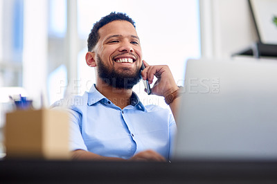 Buy stock photo Cropped shot of a handsome young businessman sitting alone in the office and using his cellphone during the day