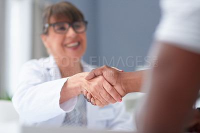 Buy stock photo Shot of a female doctor greeting a patient