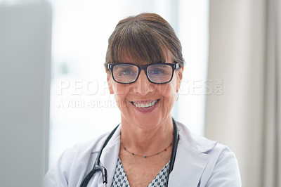 Buy stock photo Shot of a female doctor smiling at the camera in her office