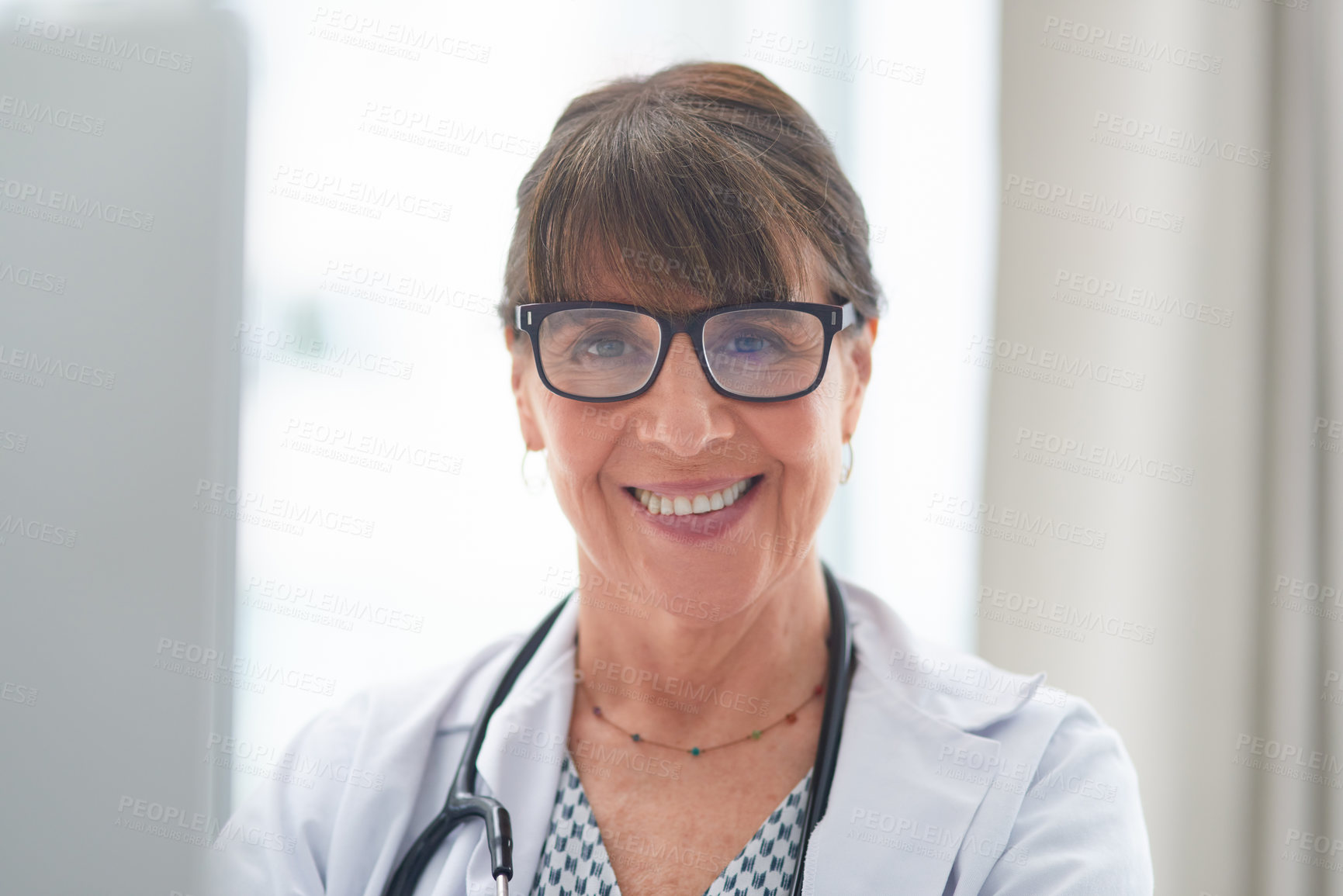 Buy stock photo Shot of a female doctor smiling at the camera in her office