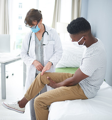 Buy stock photo Shot of a female doctor examining a male patient in her office