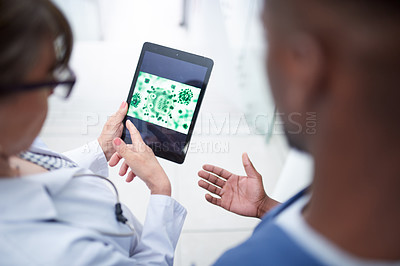 Buy stock photo Shot of a doctor looking at a tablet
