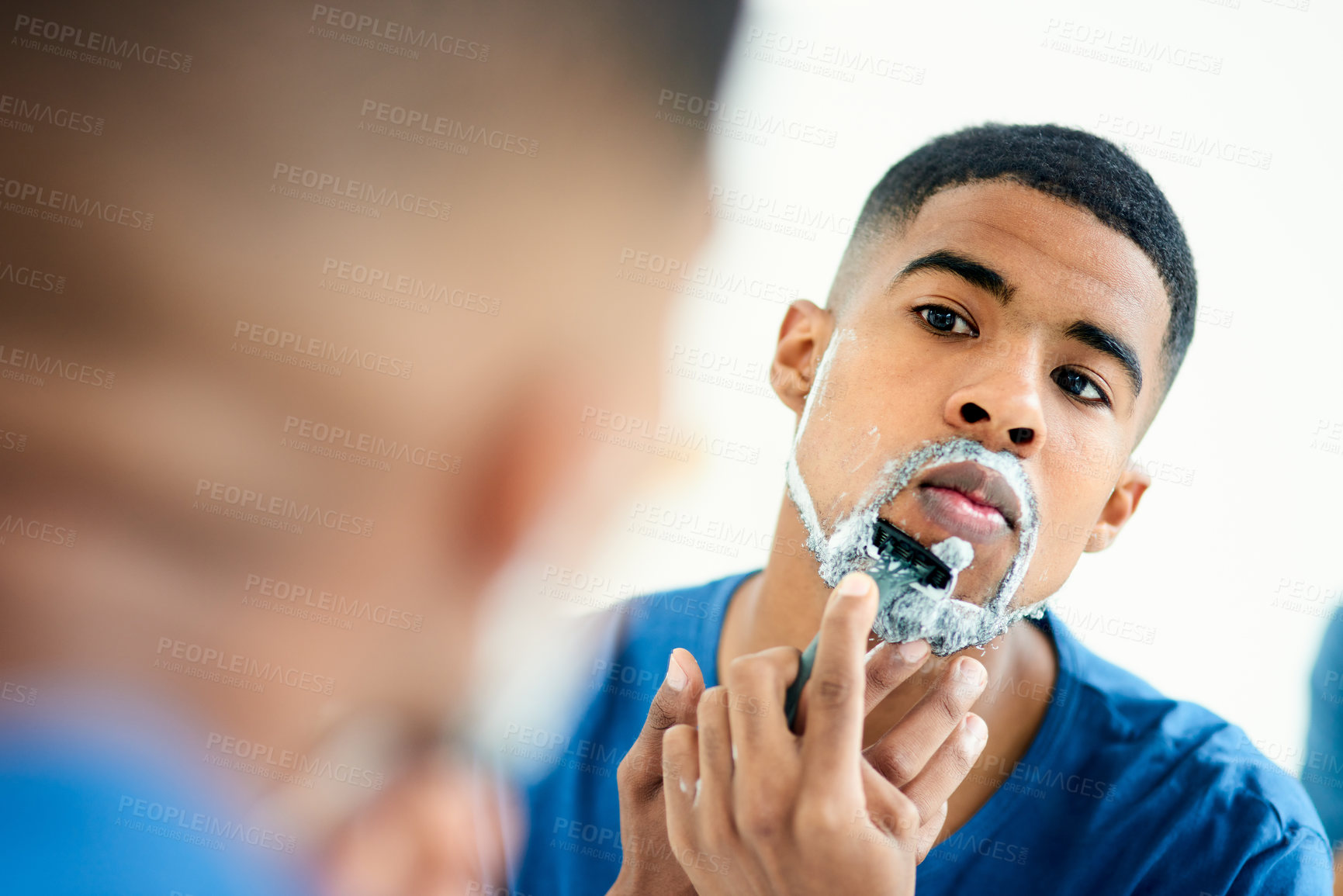 Buy stock photo Hair removal, face and shaving with man in bathroom for grooming, morning routine and cleaning. Skincare, razor and self care with male person in mirror at home for facial, beard and hygiene