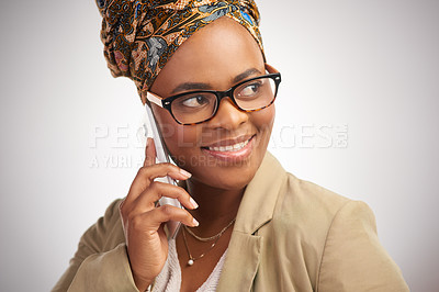 Buy stock photo Cropped shot of an attractive young woman standing alone in the studio and using a cellphone