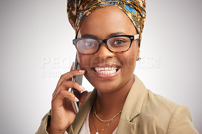 Buy stock photo Cropped portrait of an attractive young woman standing alone in the studio and using a cellphone