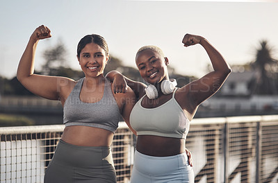 Buy stock photo Shot of two young women flexing while out for a run