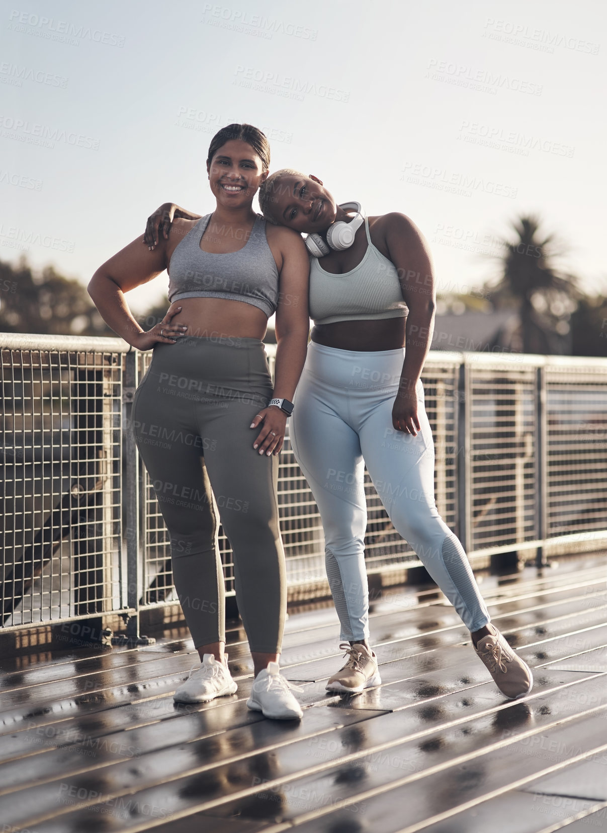 Buy stock photo Shot of two young women out for a run together