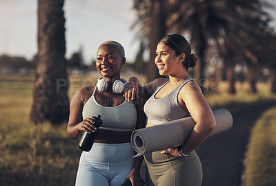 Buy stock photo Shot of two young women holding a water bottle and yoga mat while standing outside