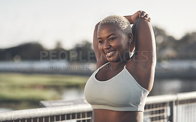 Buy stock photo Cropped shot of an attractive young woman stretching outside