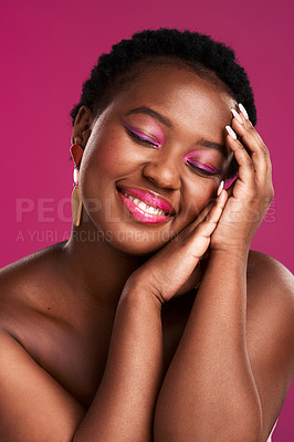 Buy stock photo Studio shot of a beautiful young woman touching her face against a pink background