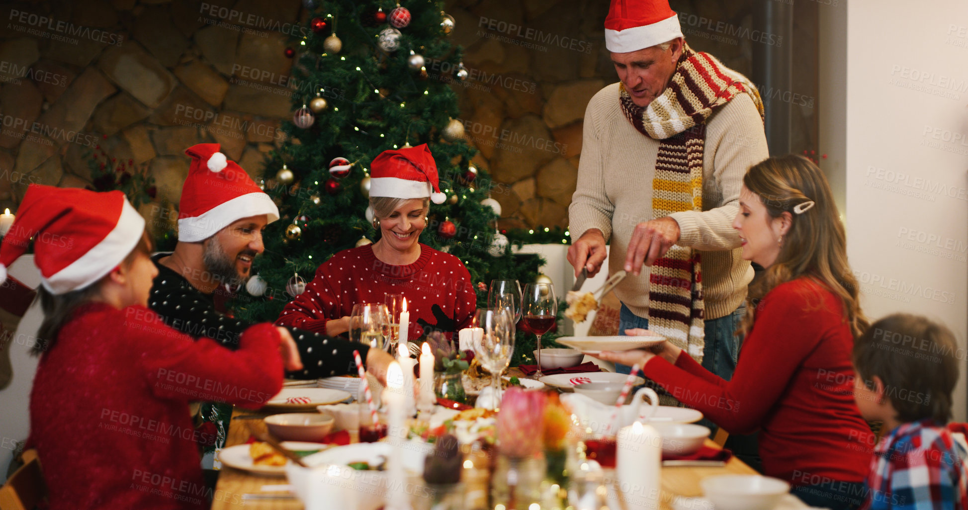 Buy stock photo Shot of a happy family having Christmas lunch together at home