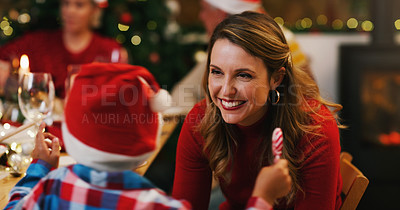 Buy stock photo Shot of a young woman enjoying a Christmas dinner party with her son and family at home