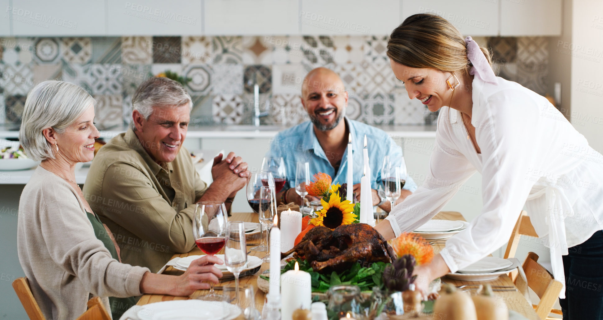 Buy stock photo Mature people, table and food for celebration, dinner party or reunion in home for holiday. Happy group, smile and event with wine for drinking, roast or hosting together in relax,  alcohol or social