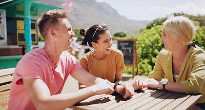 Buy stock photo Funny, friends and talking at outdoor table of restaurant, communication and happy people bonding together. Group, smile and laughing at conversation in nature for comedy, joke or story in summer