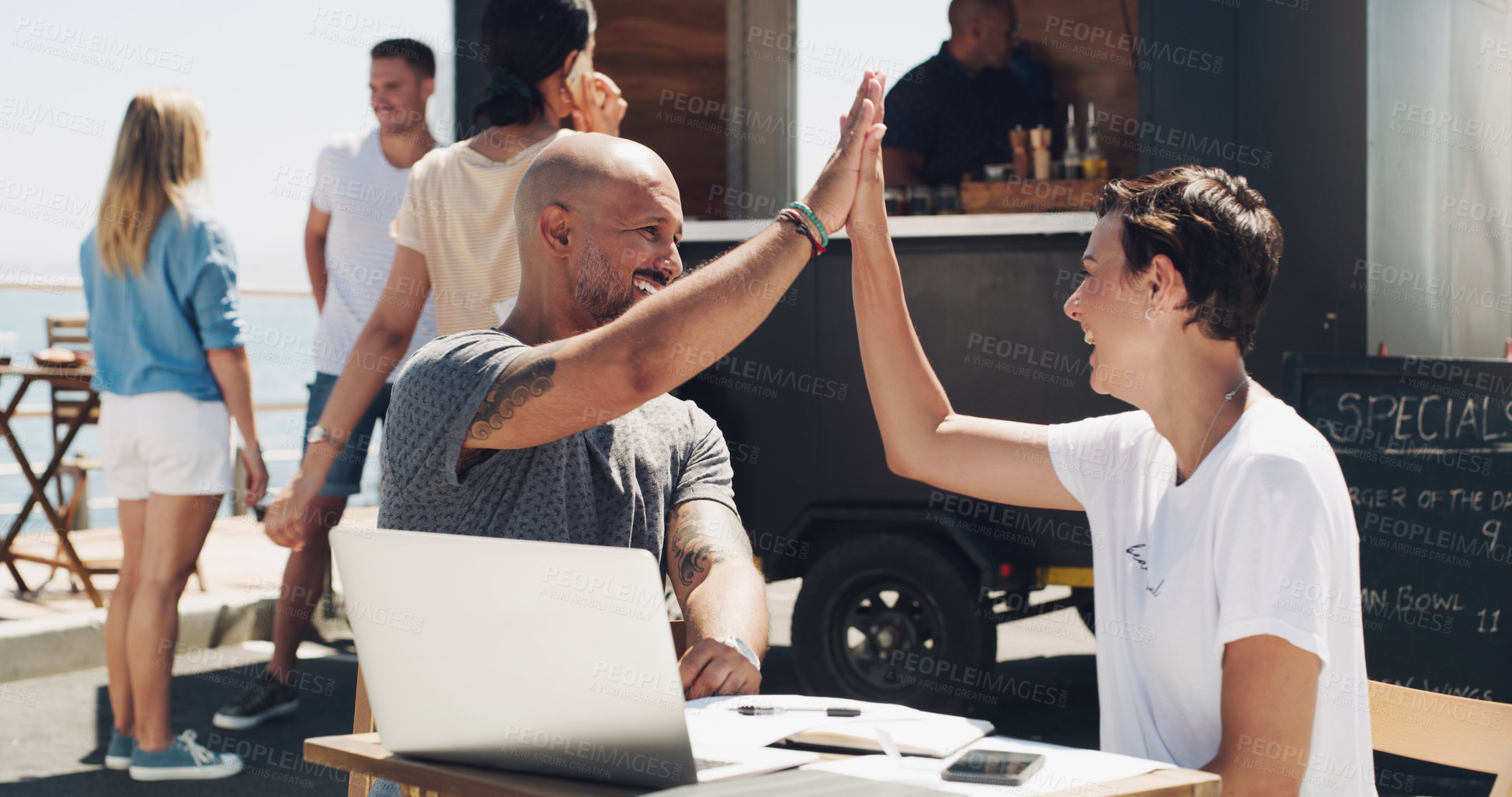 Buy stock photo Teamwork, high five and business people with laptop at food truck for celebration, target or achievement. Outdoor restaurant and colleagues with documents for collaboration, support or happiness