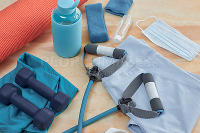 Buy stock photo Studio shot of a variety of workout equipment and PPE on a wooden floor