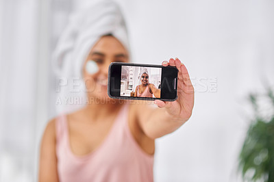 Buy stock photo Shot of a woman taking a selfie during her beauty routine