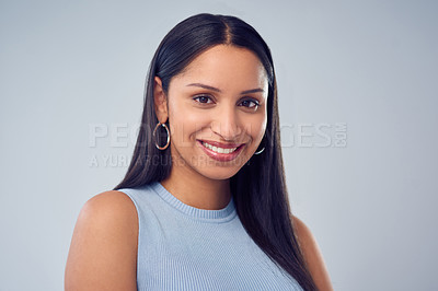 Buy stock photo Cropped portrait of an attractive young woman standing against a grey background in studio